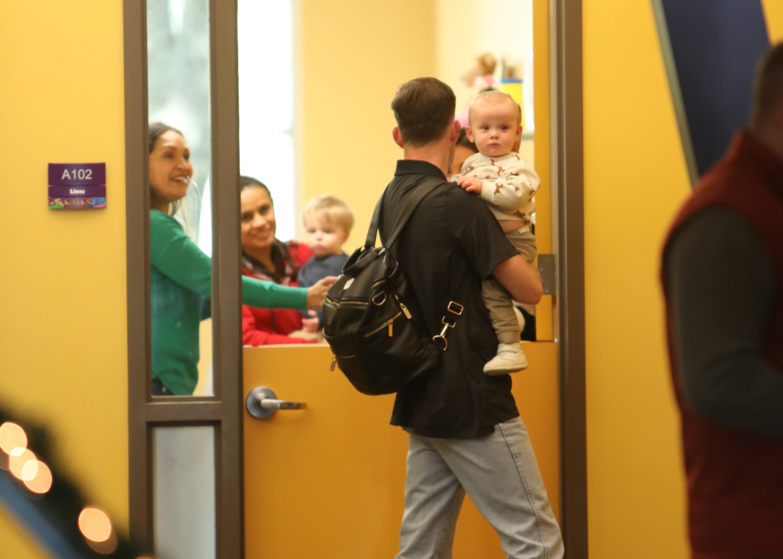 Dad picking up child from StoneBridge Nursery.